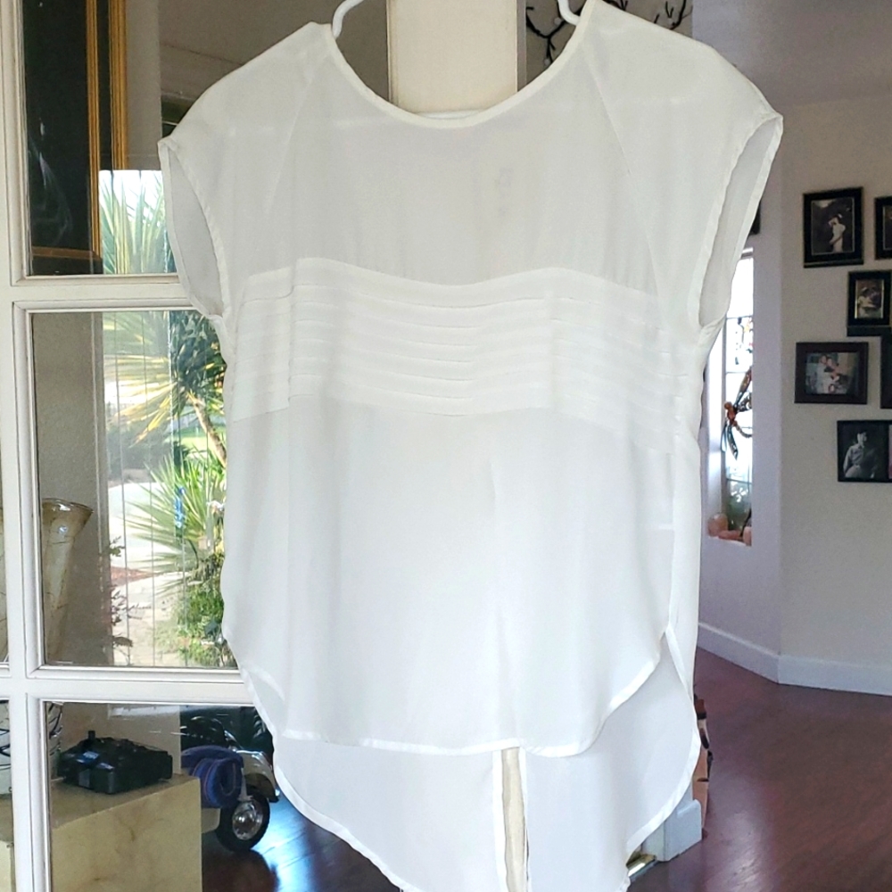 Blouse. Creme color,  size SP-P,  very blousy more like a medium.